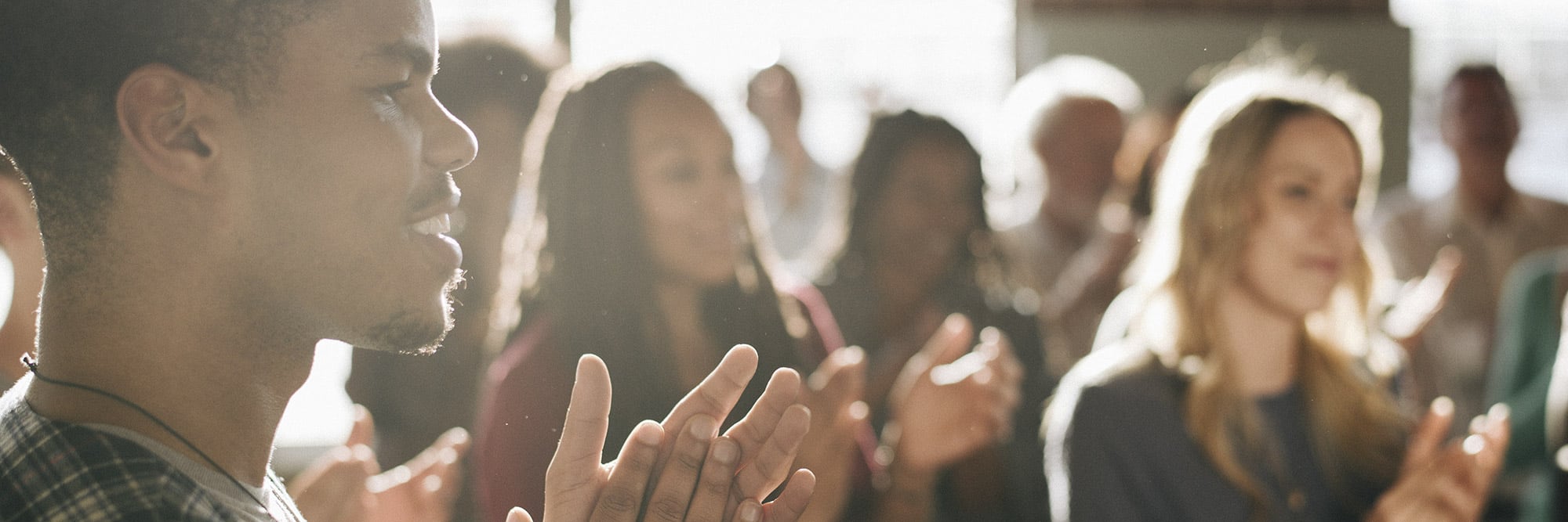 Diverse group of medical professionals clapping at medical conference