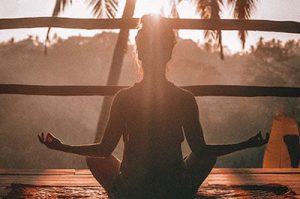 woman meditating overlooking landscape